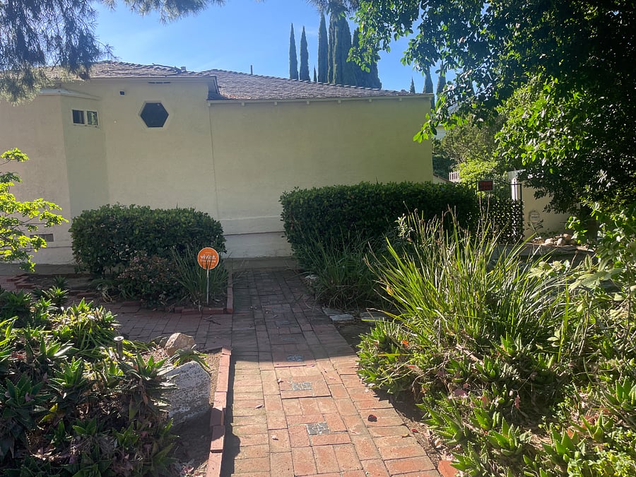 This is the private walkway from the street to the gate into your yard. The gate is to the right behind the hedges.