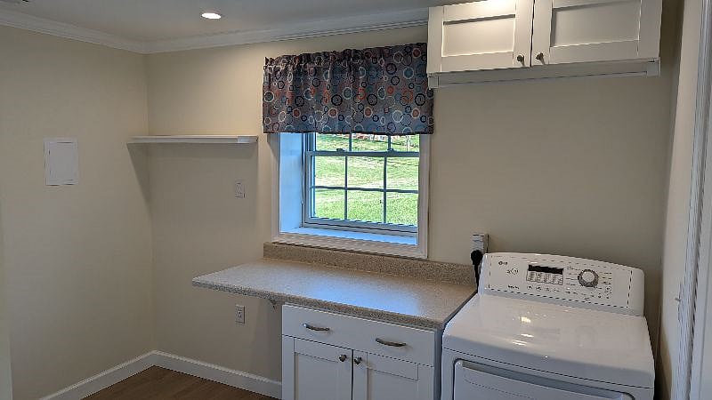 Terrace level full size dryer, extra storage, and clothes rod over dryer