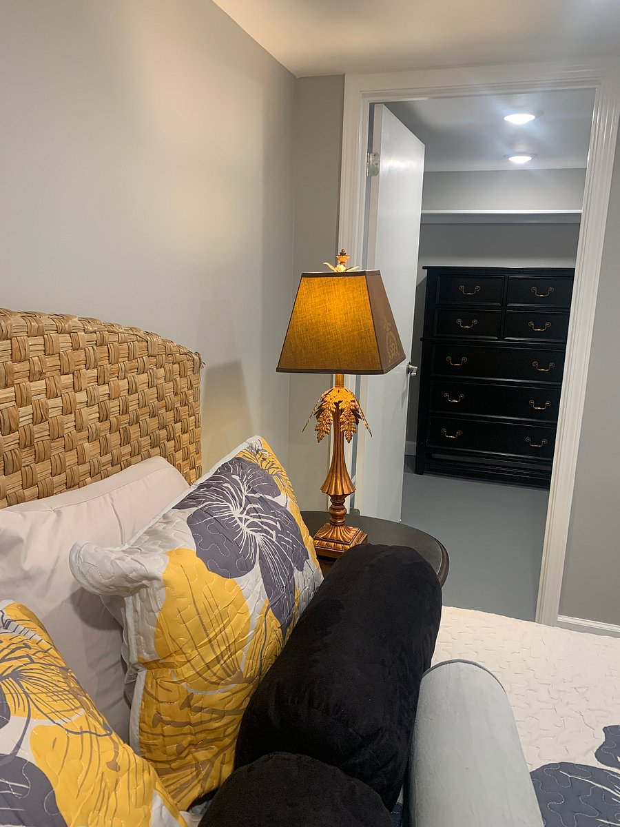Large walk in closet with a large dresser.