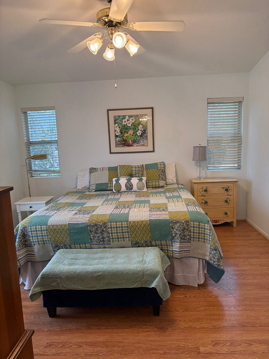 King bed. Balcony door to left.
