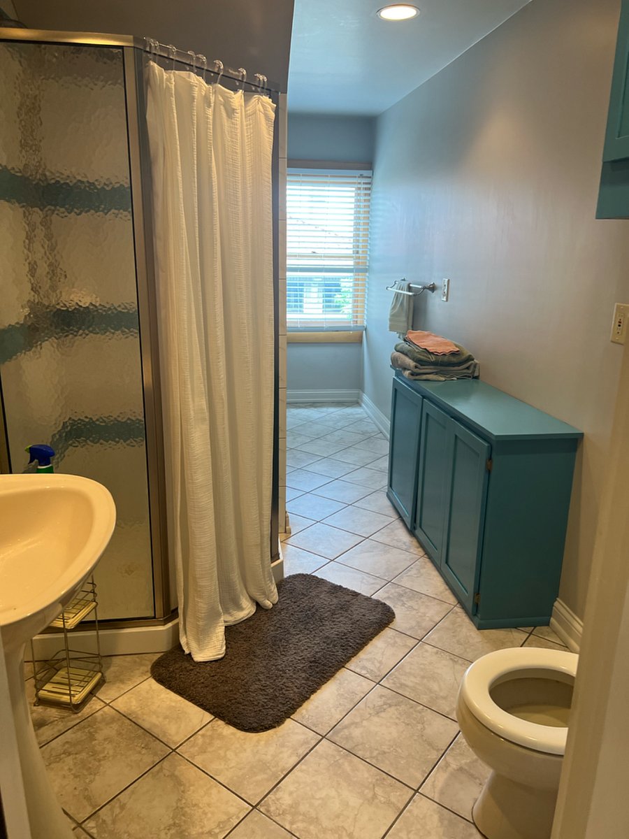 3rd floor private bathroom; shower, toilet and sink, large storage cubby