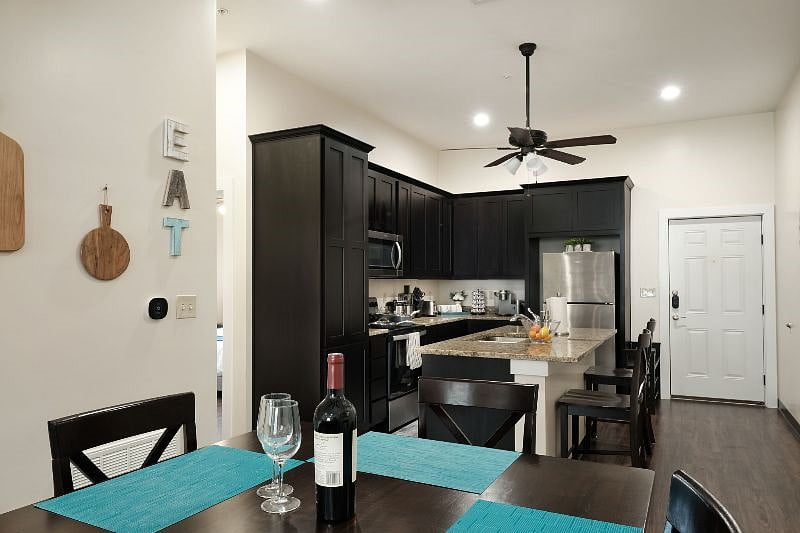 Dining room table seats 4. Kitchen island bar stools seat 2. Full table settings provided: placemats, small and large plates, cutlery, water glasses, wine glasses.
