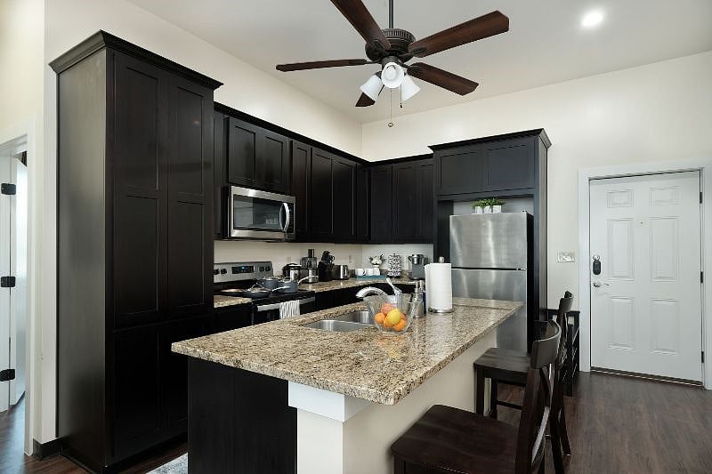 Long open plan unit leads from kitchen/dining room to an office space and then a living room. Doors from this area leas to bedrooms, bathrooms and laundry room.
