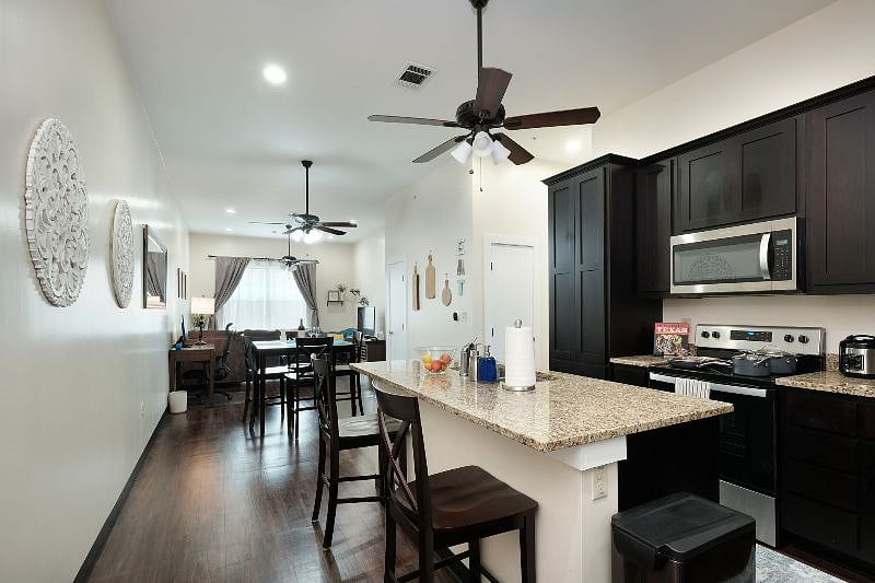 Long open plan unit leads from kitchen/dining room to an office space and then a living room. Doors from this area leas to bedrooms, bathrooms and laundry room.

