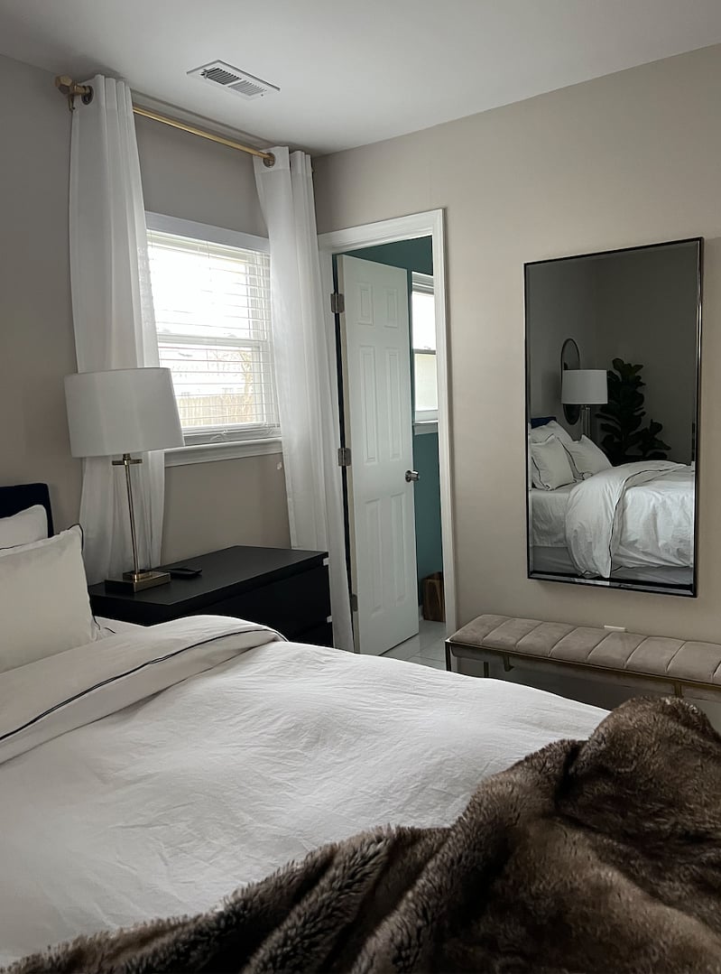 Primary Bedroom with large full length mirror and private bathroom