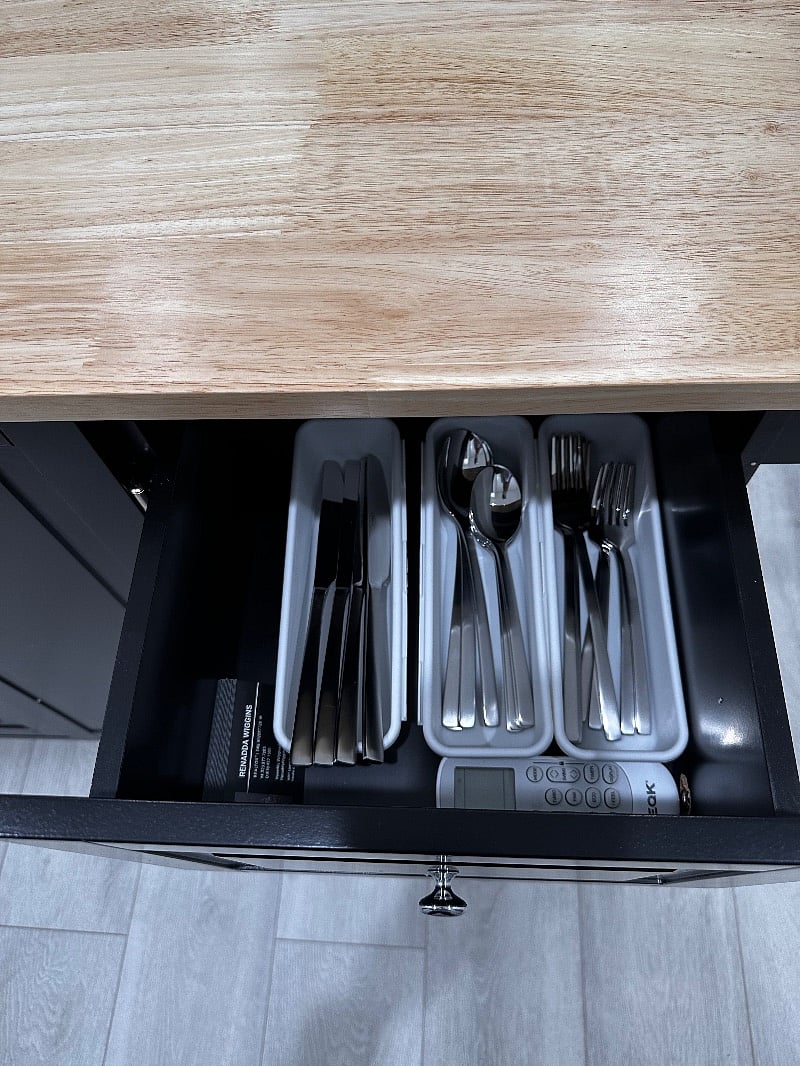 The breakfast bar is stocked with a compliment of flatware, 