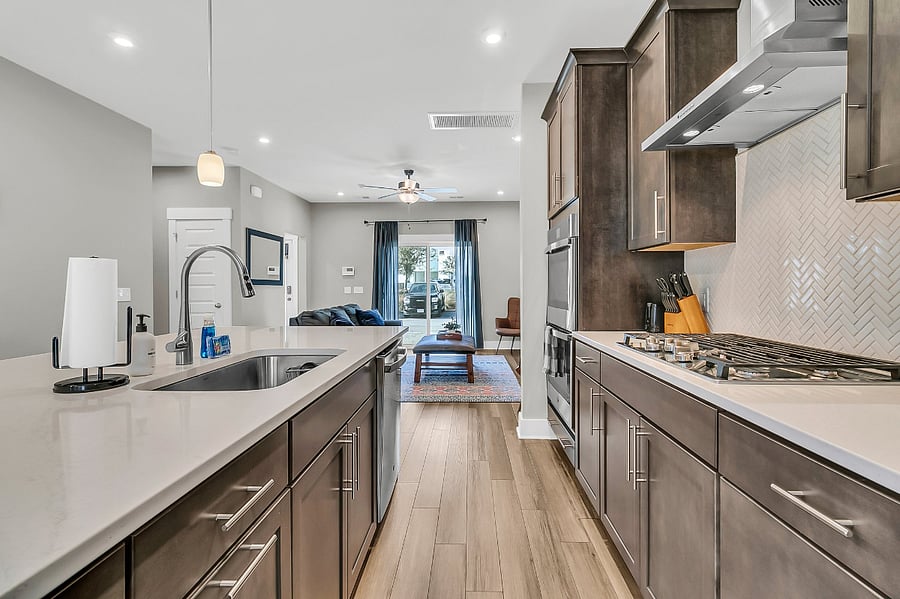 The modern chefs kitchen is fully stocked with all essentials, including a gas cooktop, large pantry, fridge, microwave, and dishwasher. Whether you're preparing a quick meal or a gourmet feast, you'll have everything you need. 