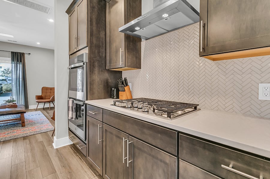 The modern chefs kitchen is fully stocked with all essentials, including a gas cooktop, large pantry, fridge, microwave, and dishwasher. Whether you're preparing a quick meal or a gourmet feast, you'll have everything you need. 
