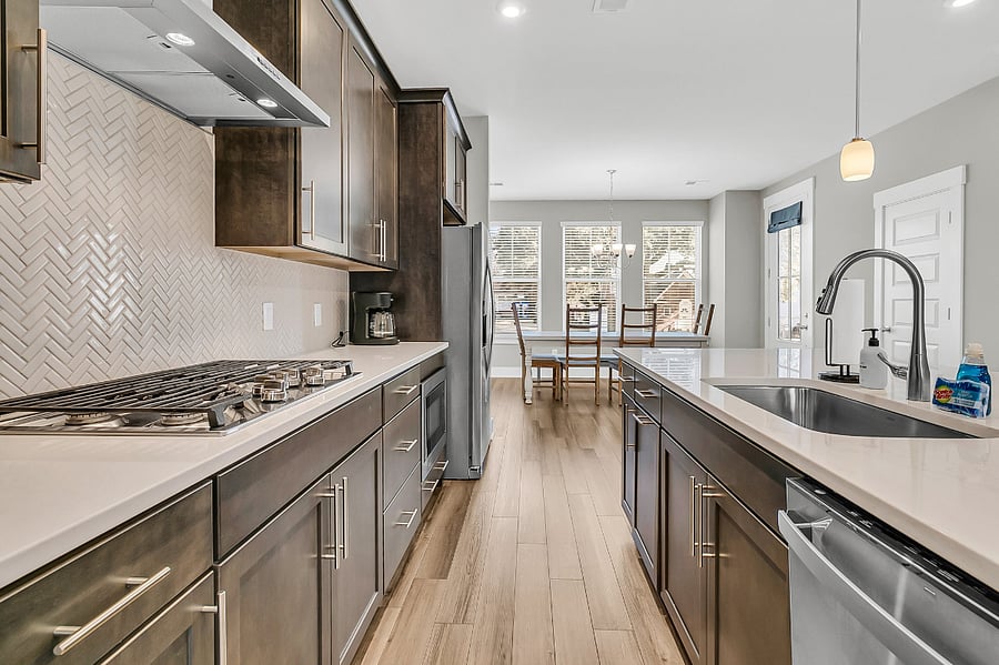 The modern chefs kitchen is fully stocked with all essentials, including a gas cooktop, large pantry, fridge, microwave, and dishwasher. Whether you're preparing a quick meal or a gourmet feast, you'll have everything you need. 