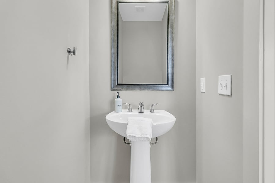Half bathroom located off the kitchen and living area