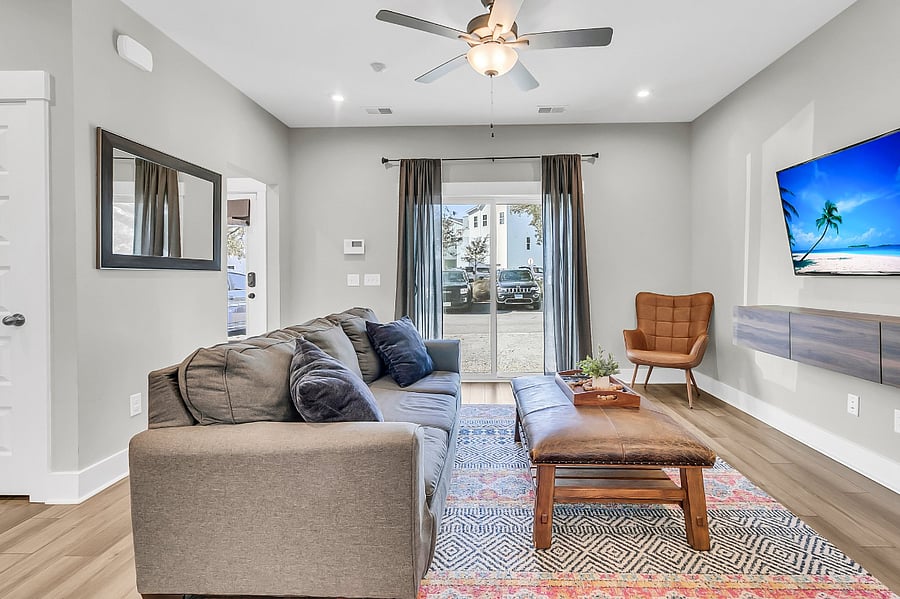 The open-concept living area offers a cozy standard couch and 2 armchairs, perfect for relaxing after a long day. A smart TV is available for entertainment.
