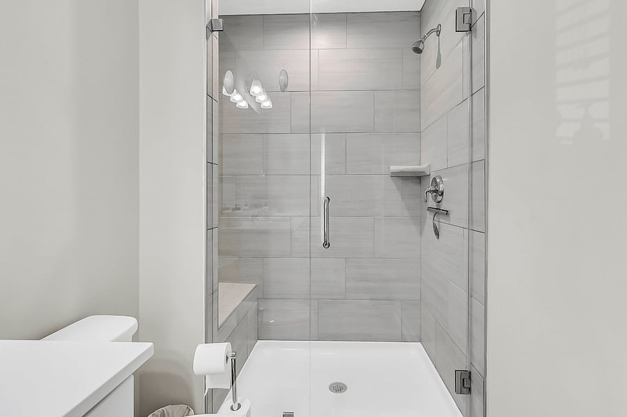 Bathroom #1, the en-suite to the primary bedroom, includes a walk-in shower and single vanity. Starter toiletries provided.