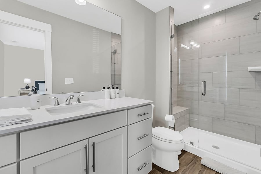Bathroom #1, the en-suite to the primary bedroom, includes a walk-in shower and single vanity. Starter toiletries provided.