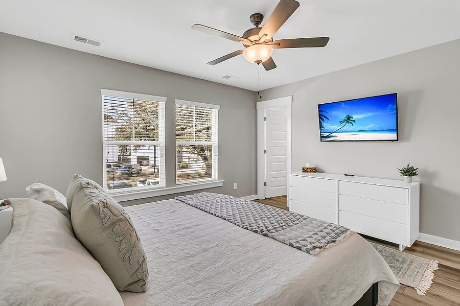 Bedroom #1, the primary suite, includes a king-sized bed, large closet, smart TV, and an en-suite bath with a spacious walk-in shower.
