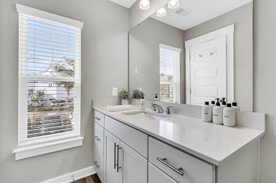 Bathroom #1, the en-suite to the primary bedroom, includes a walk-in shower and single vanity. Starter toiletries provided.
