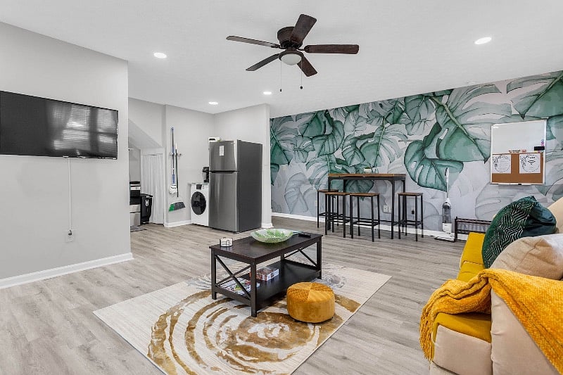 Spacious, open living room area w/ beautiful greenery accent wall! 
43inch Roku TV