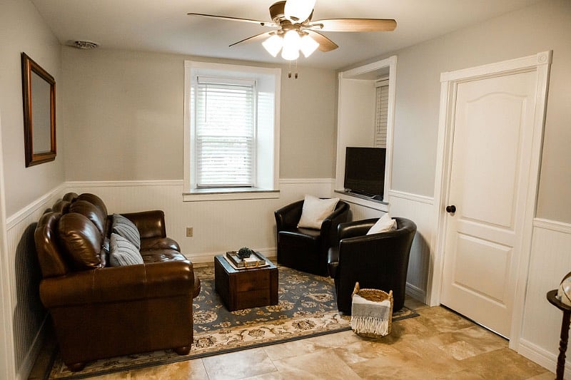 Living room with tv screen with blu - ray player that connects to wifi.