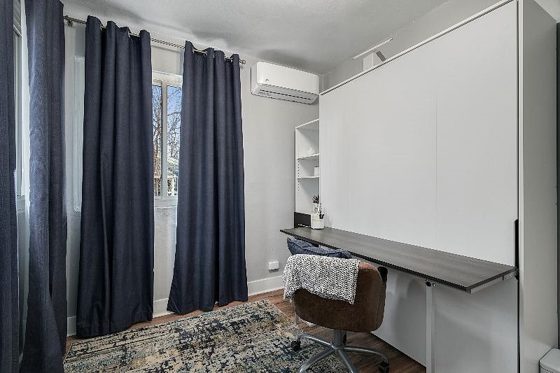 This main floor office includes white board, office supplies and safe
