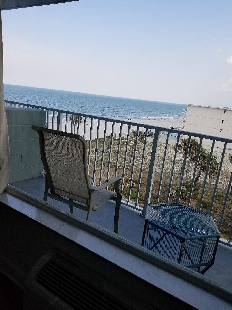Situp on our bed watching TV and looking out to the Ocean and beaches.
