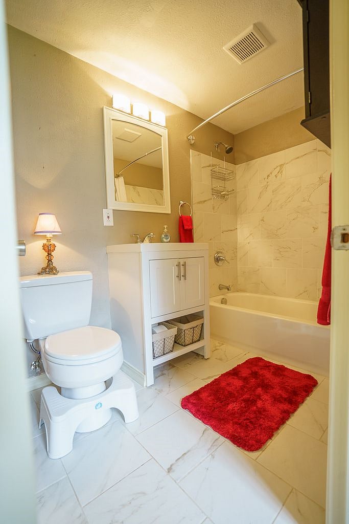 This house has a super roomy full size bathroom with a full size tub, a brand new rainwater shower head and hand held shower head (not pictured)