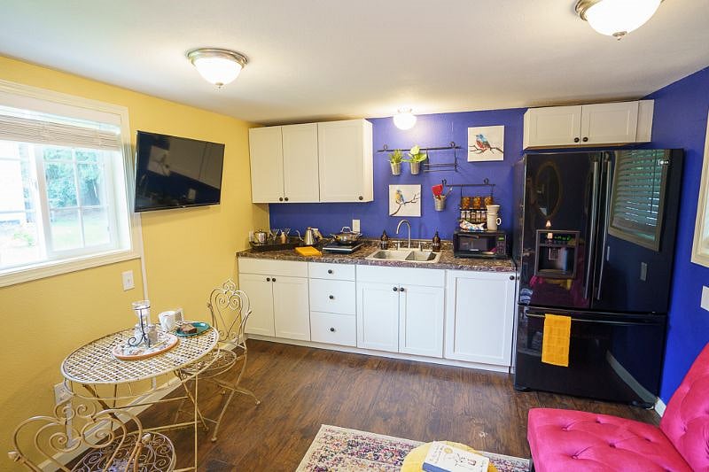 The cute little kitchenette comes with a microwave, countertop burner and a full size refridgerator. You can see the little bistro table here