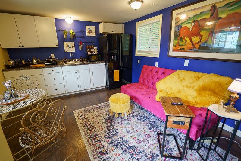 The living room/kitchen area comes with this adorable, new couch that can fold down into a full size bed.