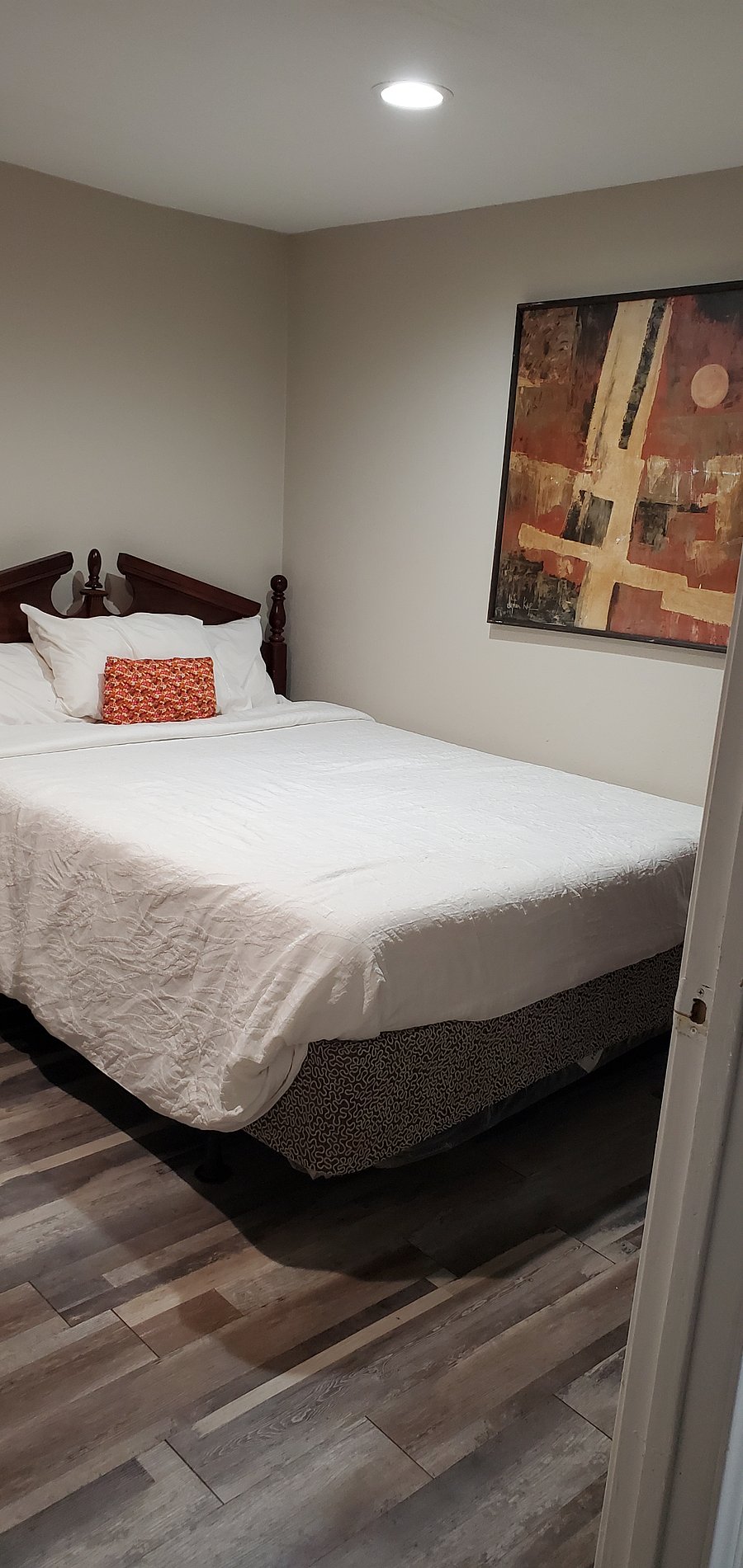 BEDROOM FEATURES A QUEEN SIZE BED, DRESS, 42" TV , NICE SIZE CLOSET WHERE YOU'LL FIND EXTRA BEDDING, IRON, IRONING BOARD , DRAWERS AND A TV TABLE.