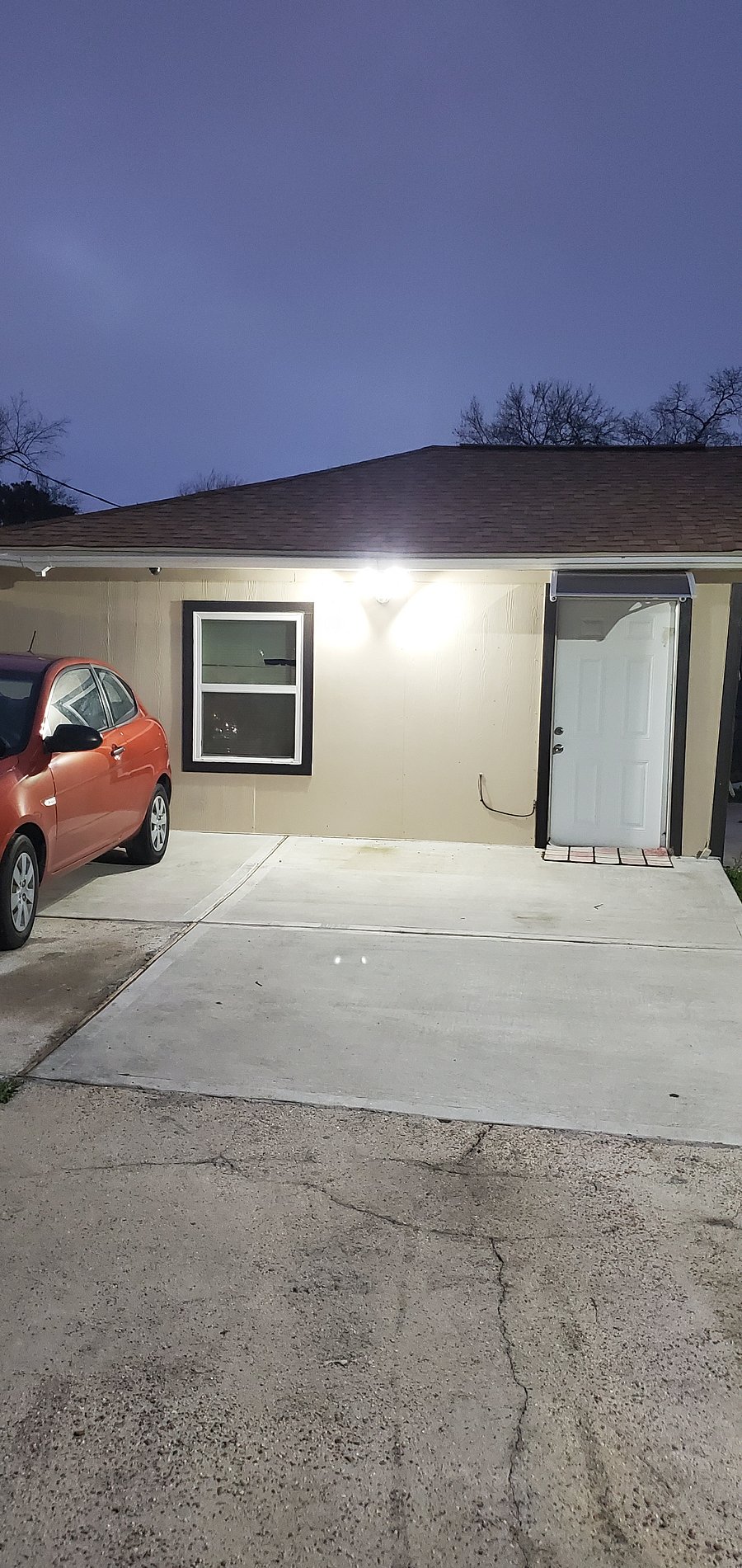 FRONT ENTRANCE OF MOTHER-IN-LAW'S UNIT WITH ACCESSIBLE PARKING ON SITE.