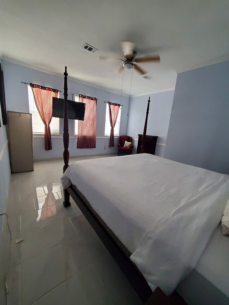 NICE SIZE COZY RREAR VIEW OF ROOM 8 FEATURING KING SIZE BED, AND 55" SMART TV.