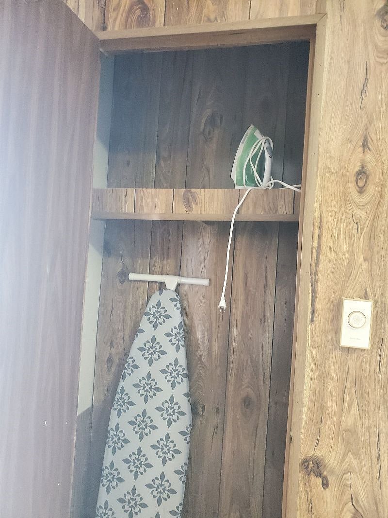 Full Size ironing board and iron. Located in Bedroom # 2 Closet.