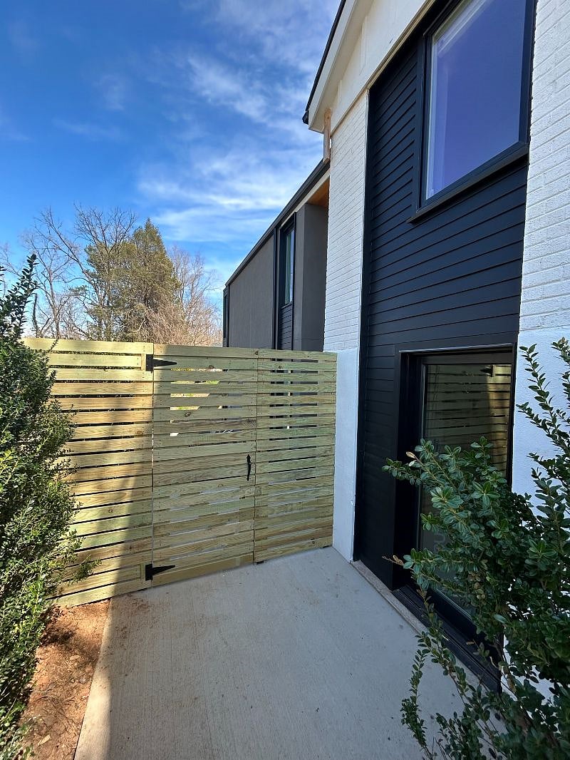 Gate to private sideyard.  Glass door to the right is owner access to main walkout basement.