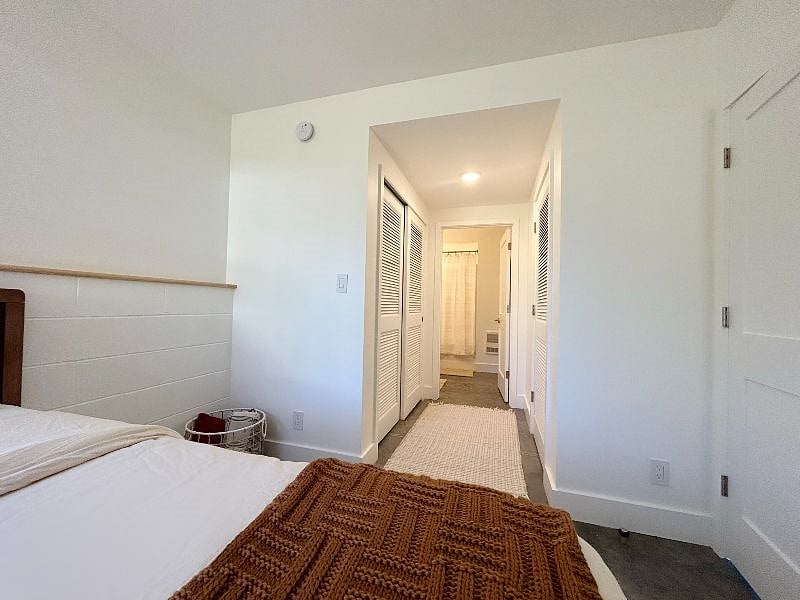 View from bedroom to closet hall and full bathroom.