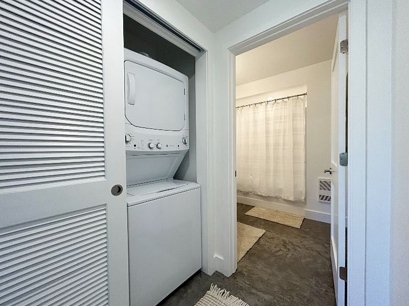 stacked in-unit washer dryer and full bathroom.