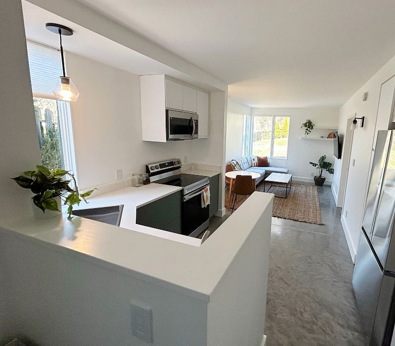 View from entry foyer down to open kitchen/living space.