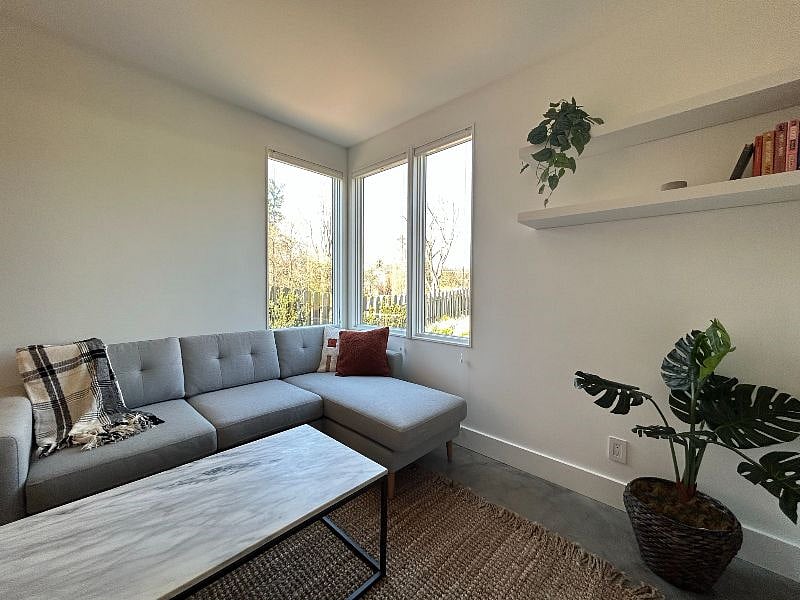 Sectional couch with built-in USB phone charger and corner window to private backyard.