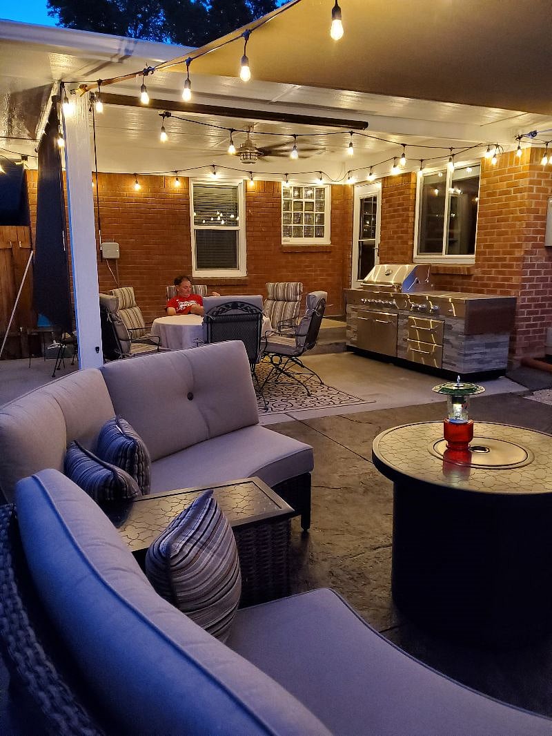 Shared patio space with fireplace, barbque, and patio furniture