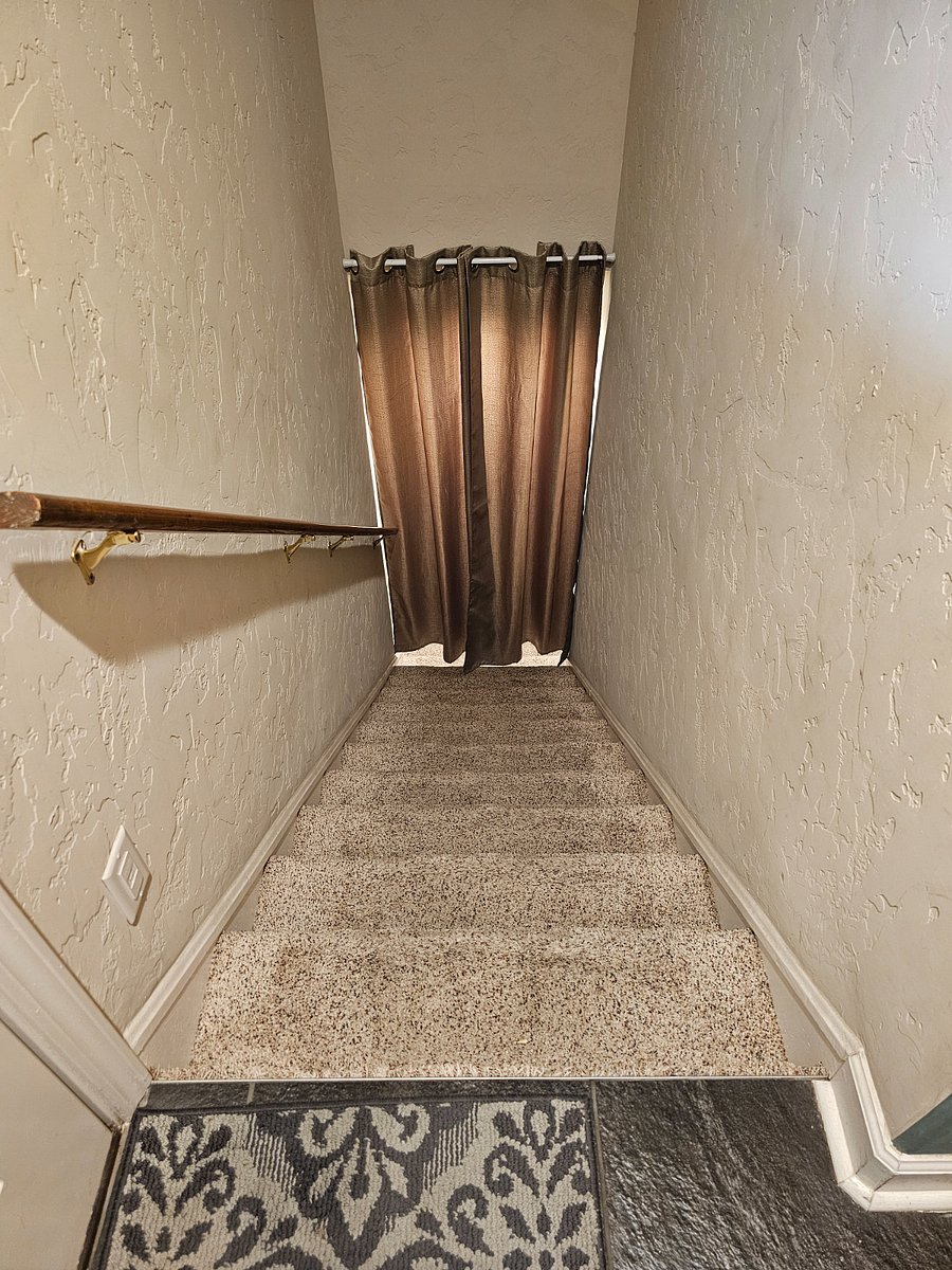 Stairs to the basement. Curtain provides further privacy and maintains heat in the well-insulated basement