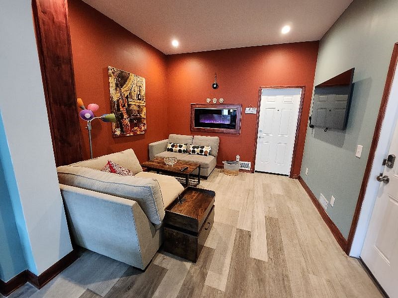 Shared Space- Living room/TV, wall in fireplace and laudry room entryway are shown.