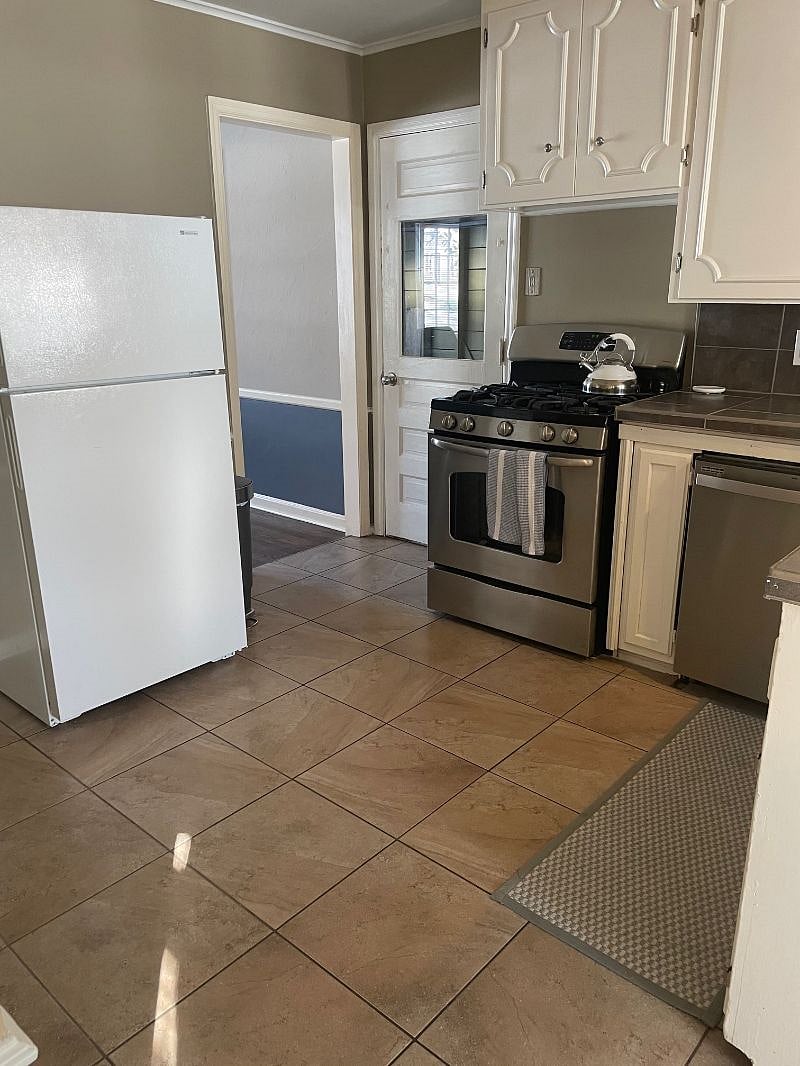 Kitchen with gas range and newer dishwasher