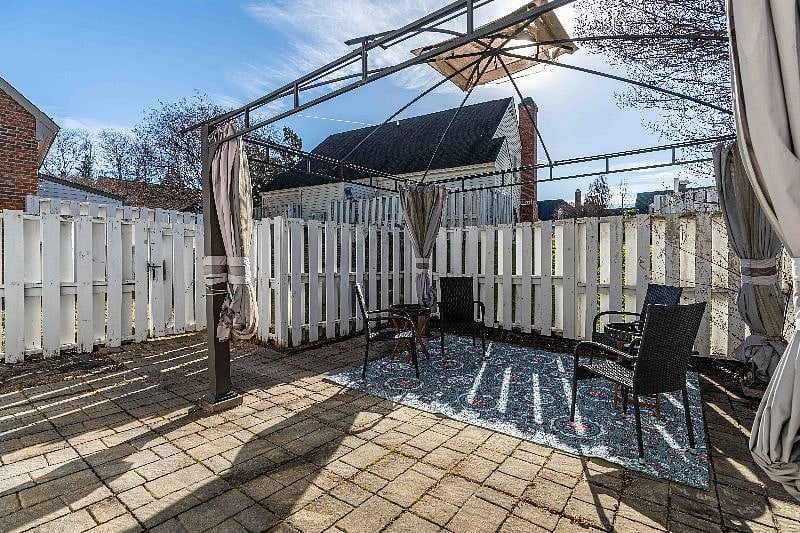 The outdoor space is fenced-in and includes furniture, a grill and an outdoor locked storage shed for your bike or kayak.
