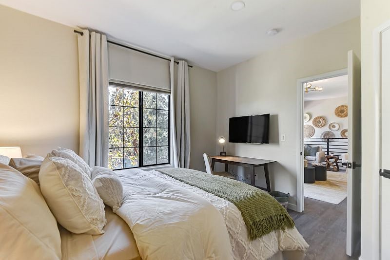 Experience comfort and productivity in our spacious master bedroom, complete with a dedicated workspace desk for your work-from-home needs