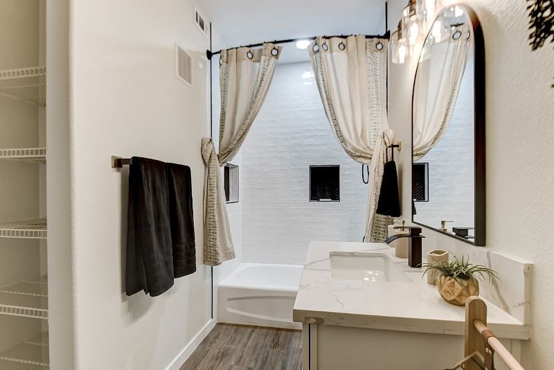 Unwind in luxury in our spacious master bathroom, featuring a relaxing shower/bathtub combination for the ultimate relaxation after a long day in the city