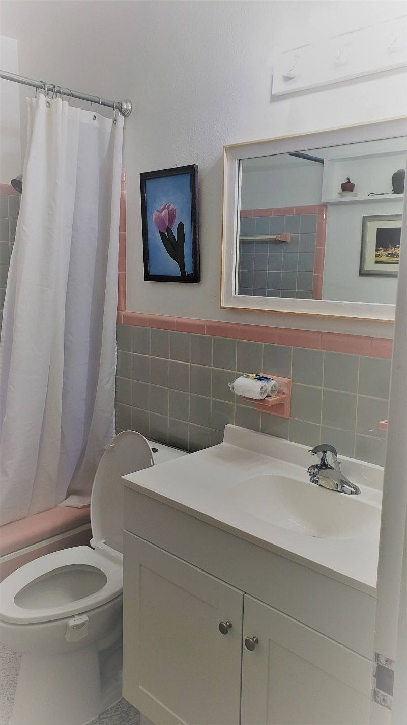 Full bathroom with original tilework.