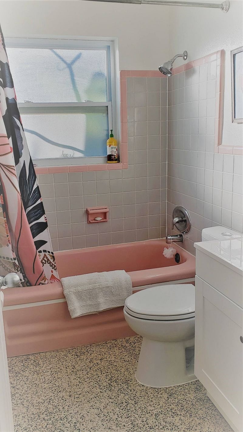 Full bathroom with original tilework.