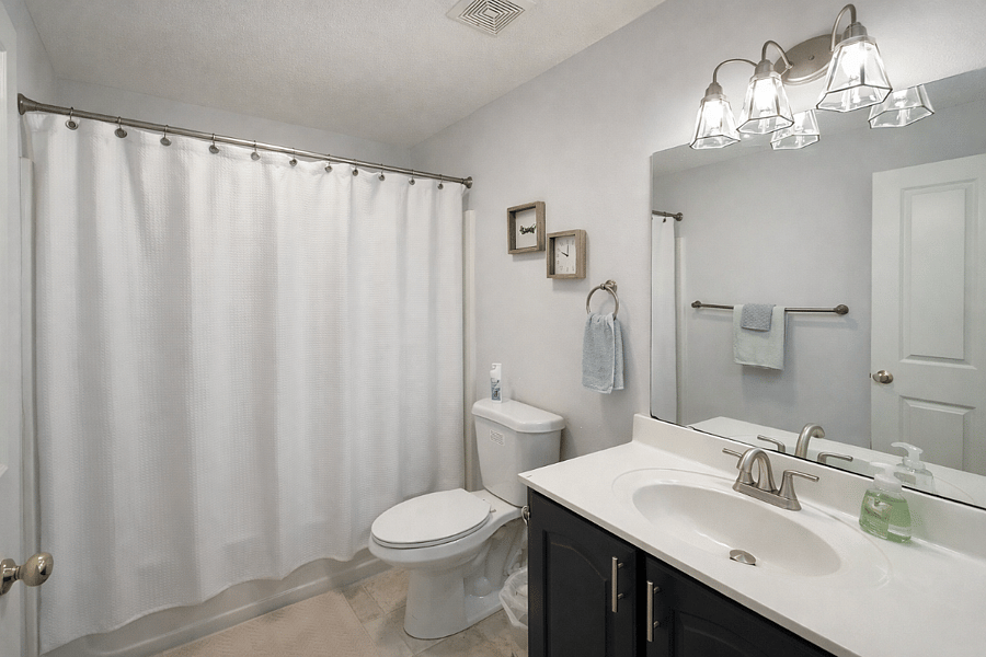 Clean, modern bathroom featuring a rain showerhead for a refreshing start or end to your day.