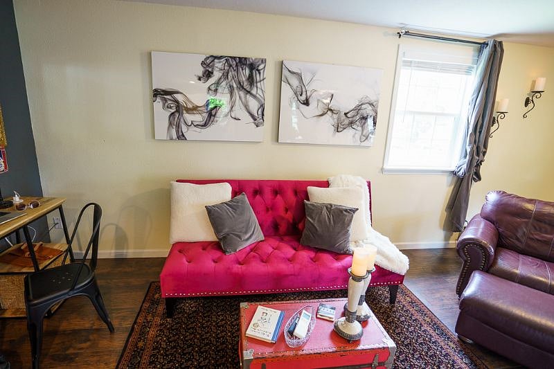 Cool red couch placed perfectly for cozy movie night