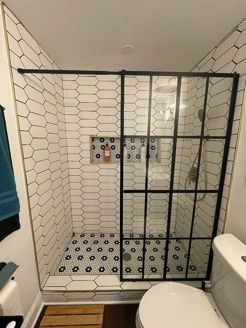 Shower with body wash, shampoo and conditioner.