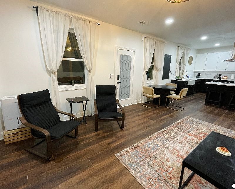 Dining table and lounge chairs in the open concept living area.