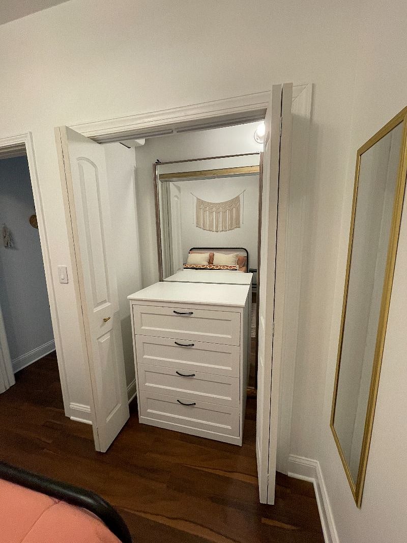 Dresser and mirror in the closet.