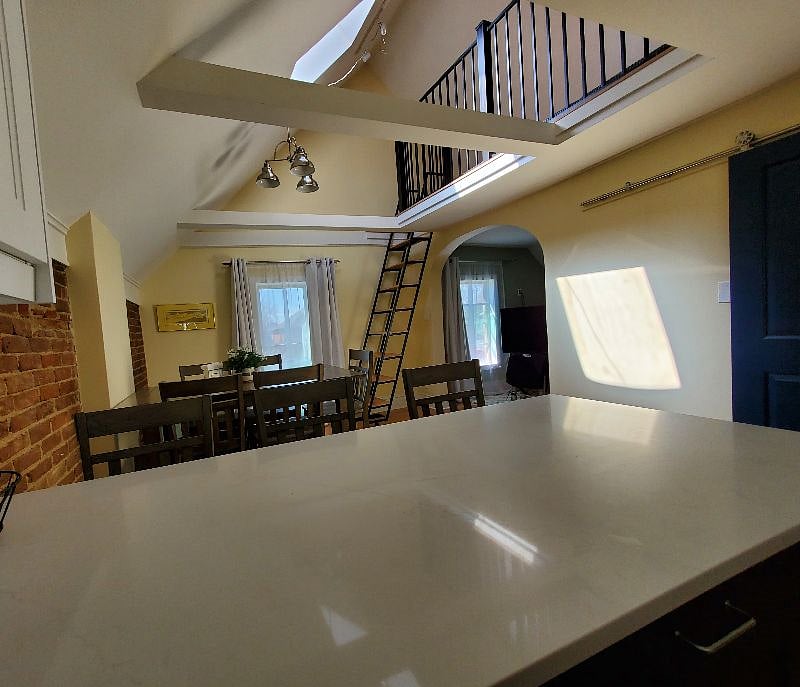 View from kitchen to dining room and loft above the living room